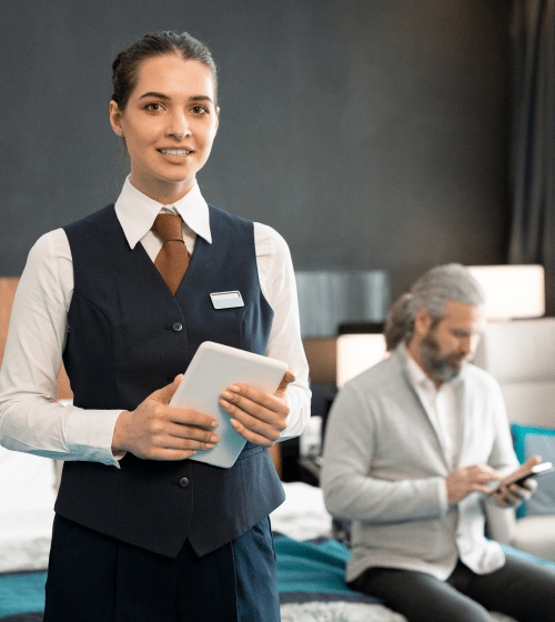 young-successful-hotel-manager-with-touchpad-standing